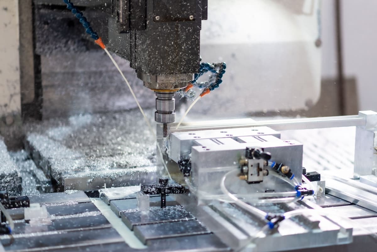 A CNC milling machine cutting a metal workpiece